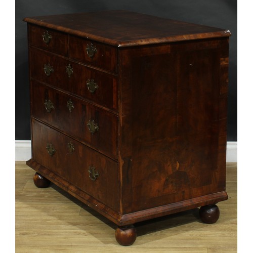 2351 - A Queen Anne walnut chest, featherbanded top above two short and three long graduated drawers, skirt... 