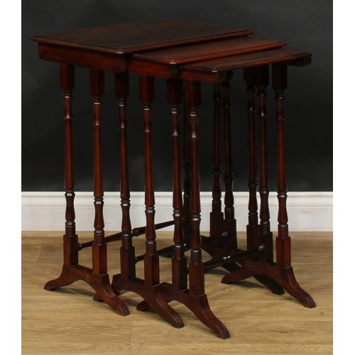 1857 - A nest of three William IV rosewood occasional tables, rounded rectangular tops, turned supports and... 