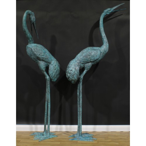 2415 - A pair of substantial contemporary copper alloy garden models, as waterbirds, the largest 247cm high... 