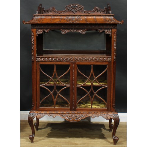 1647 - A Chinese Chippendale style mahogany pagoda-form display cabinet, rectangular top above a mirror-bac... 