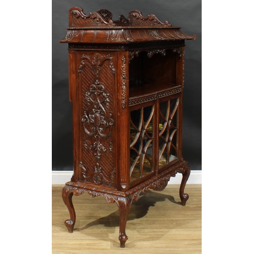 1647 - A Chinese Chippendale style mahogany pagoda-form display cabinet, rectangular top above a mirror-bac... 