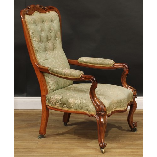 2601 - A Victorian rosewood library chair, stuffed-over upholstery, serpentine seat, cabriole forelegs, bra... 