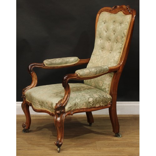 2601 - A Victorian rosewood library chair, stuffed-over upholstery, serpentine seat, cabriole forelegs, bra... 