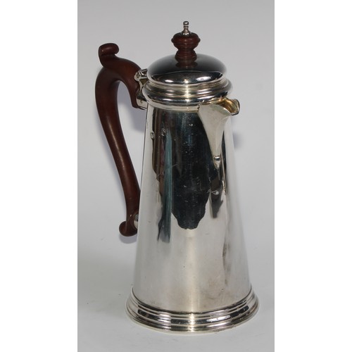 1069 - A silver spreading cylindrical coffee pot and hot water jug, in George I style, domed cover, composi... 