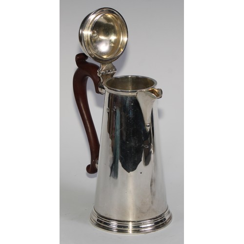 1069 - A silver spreading cylindrical coffee pot and hot water jug, in George I style, domed cover, composi... 