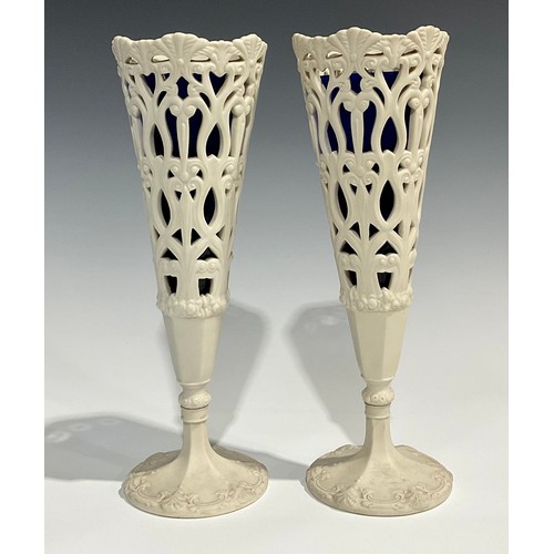 130 - A pair of 19th century Copeland Parian reticulated conical vases, pedestal bases, blue glass liners,... 