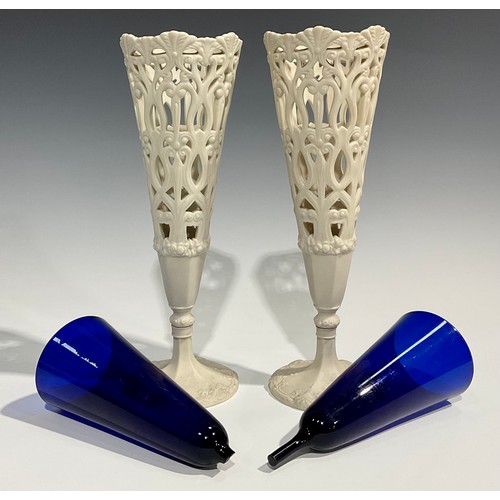 130 - A pair of 19th century Copeland Parian reticulated conical vases, pedestal bases, blue glass liners,... 