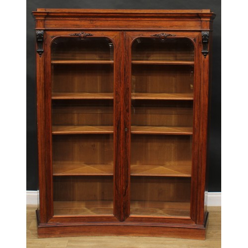 1720 - A 19th century rosewood concave library bookcase, moulded cornice above a pair of bevelled glazed do... 