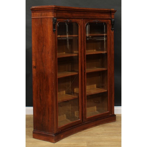 1720 - A 19th century rosewood concave library bookcase, moulded cornice above a pair of bevelled glazed do... 