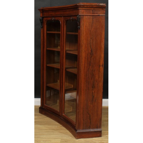 1720 - A 19th century rosewood concave library bookcase, moulded cornice above a pair of bevelled glazed do... 