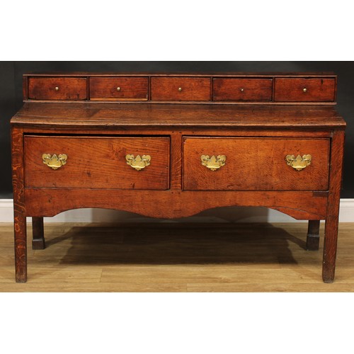 2042 - A George III vernacular oak low dresser, rectangular top applied with a row of five small drawers ab... 