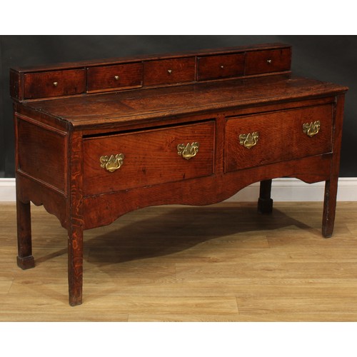 2042 - A George III vernacular oak low dresser, rectangular top applied with a row of five small drawers ab... 