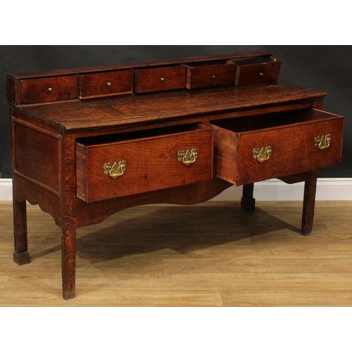 2042 - A George III vernacular oak low dresser, rectangular top applied with a row of five small drawers ab... 