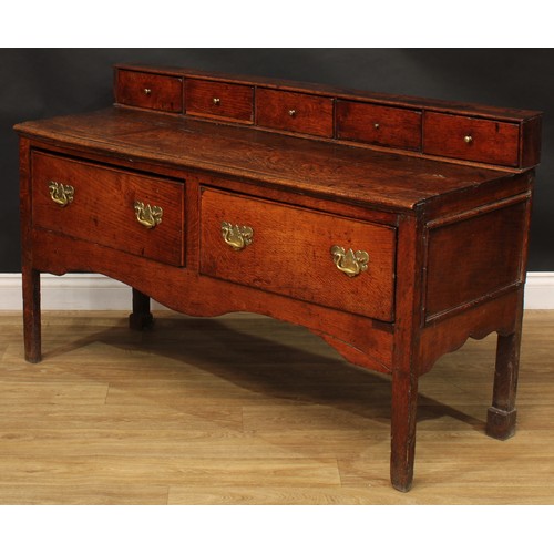 2042 - A George III vernacular oak low dresser, rectangular top applied with a row of five small drawers ab... 