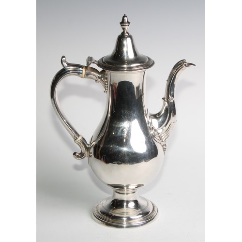 909 - A George III Provincial silver baluster coffee pot, hinged cover with acorn finial, scroll handle, d... 