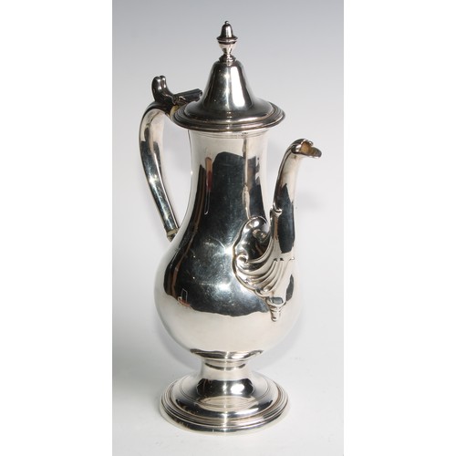 909 - A George III Provincial silver baluster coffee pot, hinged cover with acorn finial, scroll handle, d... 