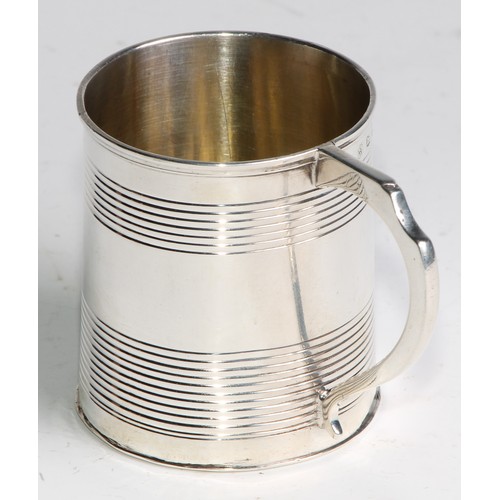 939 - A George III silver slightly spreading cylindrical mug, reeded bands, scroll handle, 6.5cm high, Tho... 