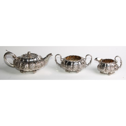 950 - A George IV silver three piece melon shaped tea service, comprising teapot, milk jug and sugar basin... 