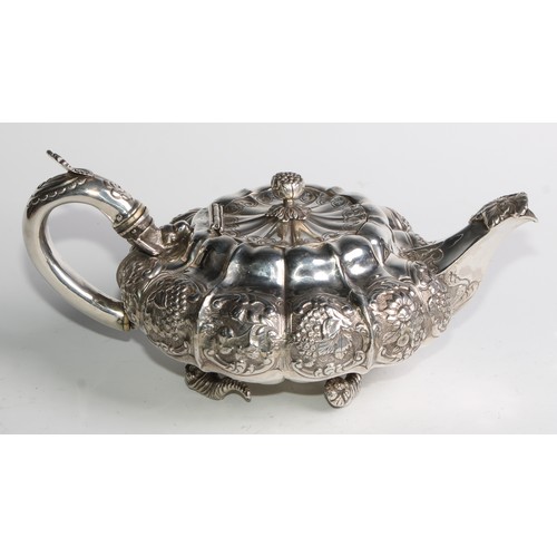 950 - A George IV silver three piece melon shaped tea service, comprising teapot, milk jug and sugar basin... 