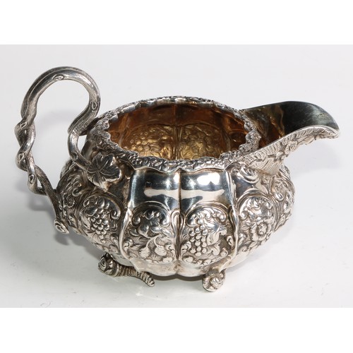 950 - A George IV silver three piece melon shaped tea service, comprising teapot, milk jug and sugar basin... 