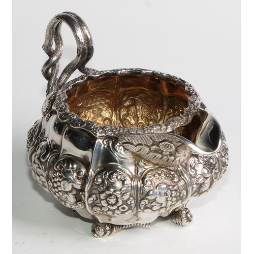 950 - A George IV silver three piece melon shaped tea service, comprising teapot, milk jug and sugar basin... 