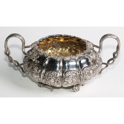 950 - A George IV silver three piece melon shaped tea service, comprising teapot, milk jug and sugar basin... 