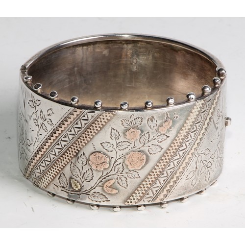 1456 - A Victorian Aesthetic Movement silver hinge bangle, 6.5cm wide, G A R, Birmingham, 1884