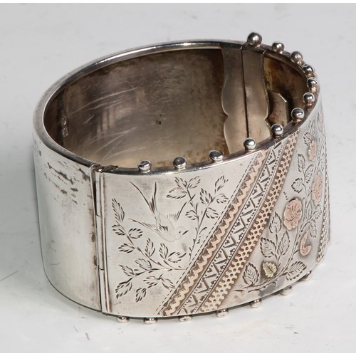 1456 - A Victorian Aesthetic Movement silver hinge bangle, 6.5cm wide, G A R, Birmingham, 1884