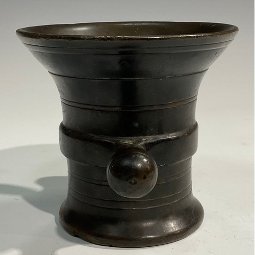 2342 - A 17th/18th century bronze mortar, flared rim above a centre girdle and reeded bands, bulbous handle... 