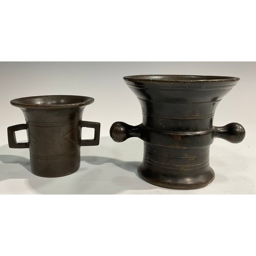 2342 - A 17th/18th century bronze mortar, flared rim above a centre girdle and reeded bands, bulbous handle... 