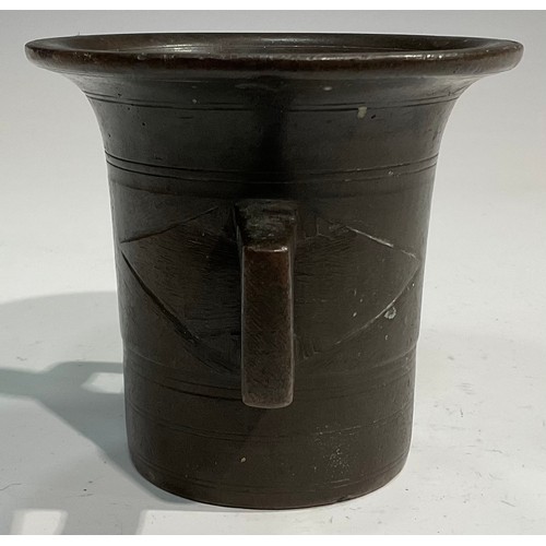 2342 - A 17th/18th century bronze mortar, flared rim above a centre girdle and reeded bands, bulbous handle... 