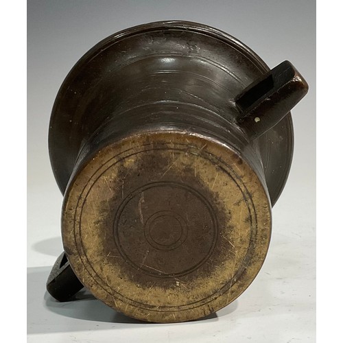 2342 - A 17th/18th century bronze mortar, flared rim above a centre girdle and reeded bands, bulbous handle... 