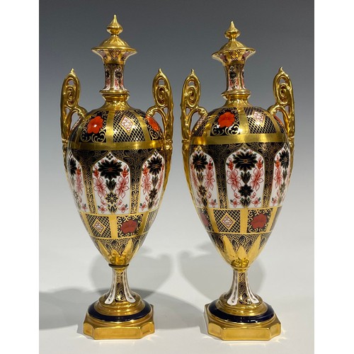 260 - A pair of Royal Crown Derby 1128 pattern pedestal ovoid vases and covers, spire finials, elaborate s... 