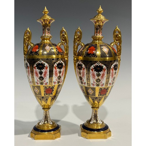 260 - A pair of Royal Crown Derby 1128 pattern pedestal ovoid vases and covers, spire finials, elaborate s... 