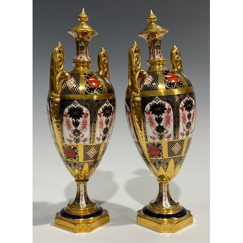 260 - A pair of Royal Crown Derby 1128 pattern pedestal ovoid vases and covers, spire finials, elaborate s... 