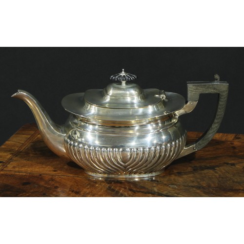 1166 - An Edwardian silver half-fluted boat shaped teapot, hinged cover, ebonised fittings, 30.5cm long, Ma... 