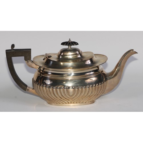 1166 - An Edwardian silver half-fluted boat shaped teapot, hinged cover, ebonised fittings, 30.5cm long, Ma... 