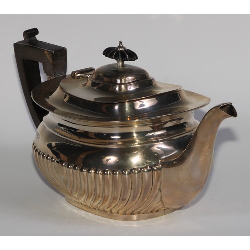 1166 - An Edwardian silver half-fluted boat shaped teapot, hinged cover, ebonised fittings, 30.5cm long, Ma... 