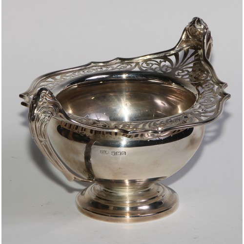 1137 - An Art Nouveau silver two handled pedestal bowl, pierced border, sinuous scroll handles, 19cm wide, ... 