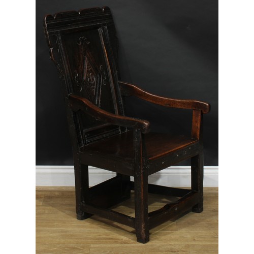 1567 - A 17th century and later oak wainscot chair, shaped rectangular back centred by a panel carved with ... 