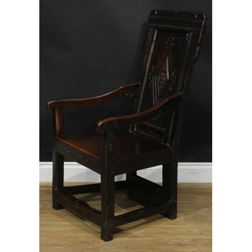 1567 - A 17th century and later oak wainscot chair, shaped rectangular back centred by a panel carved with ... 