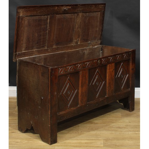 2223 - An early 18th century oak blanket chest, hinged top enclosing an open till above a three panel front... 