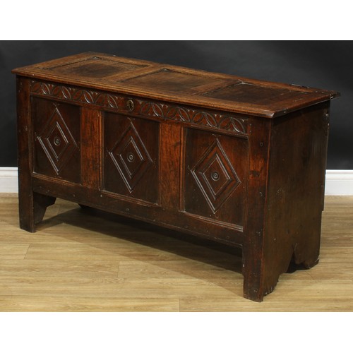 2223 - An early 18th century oak blanket chest, hinged top enclosing an open till above a three panel front... 