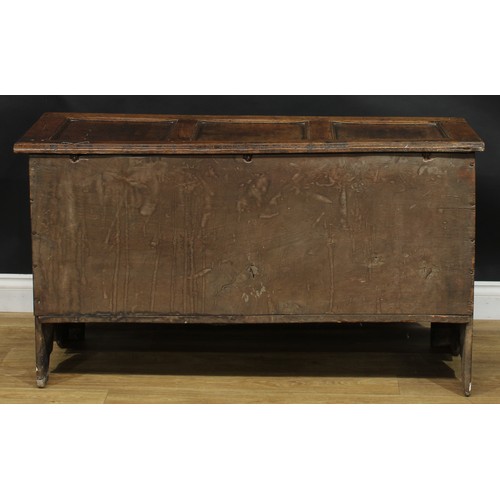 2223 - An early 18th century oak blanket chest, hinged top enclosing an open till above a three panel front... 