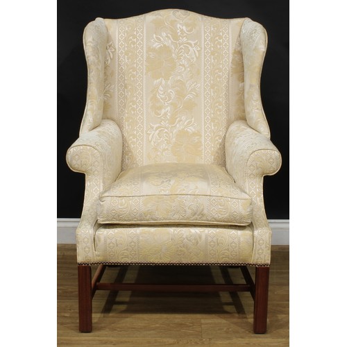 1865 - A pair of contemporary George III style wing chairs, each with stuffed-over upholstery, squab cushio... 