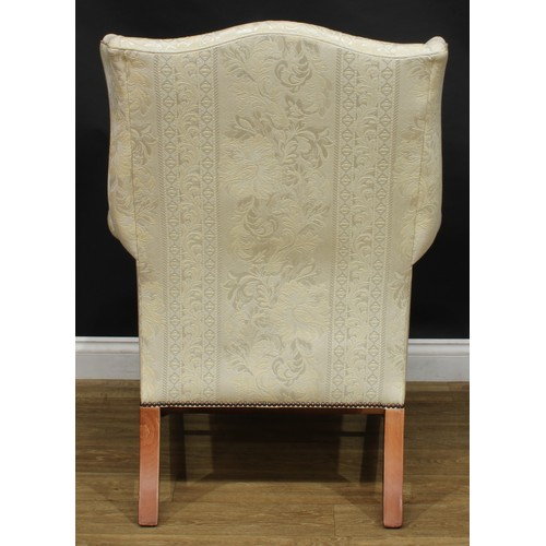 1865 - A pair of contemporary George III style wing chairs, each with stuffed-over upholstery, squab cushio... 