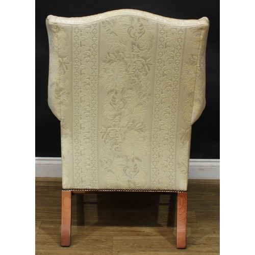 1865 - A pair of contemporary George III style wing chairs, each with stuffed-over upholstery, squab cushio... 