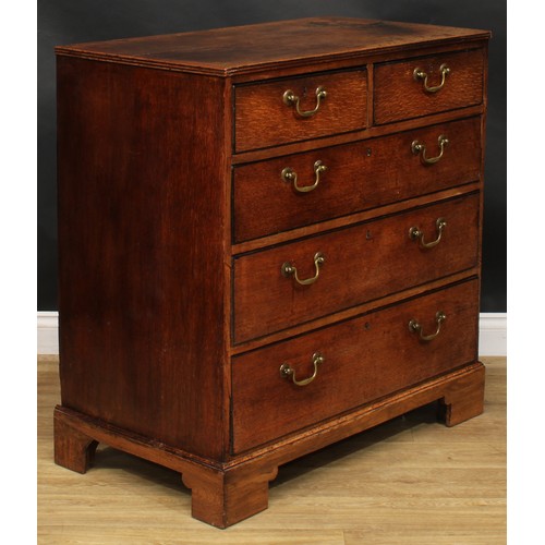 1942 - A George III oak chest, rectangular top with reeded edge above two short and three long graduated dr... 