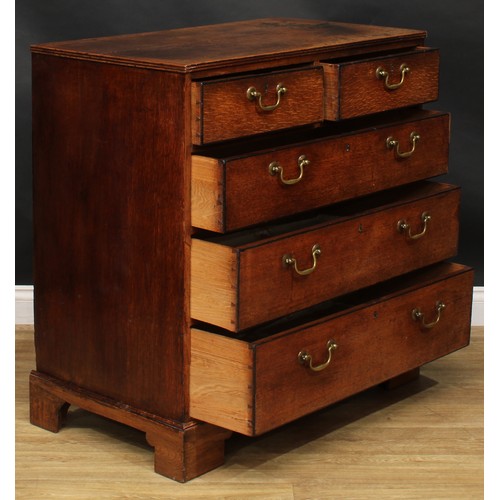 1942 - A George III oak chest, rectangular top with reeded edge above two short and three long graduated dr... 