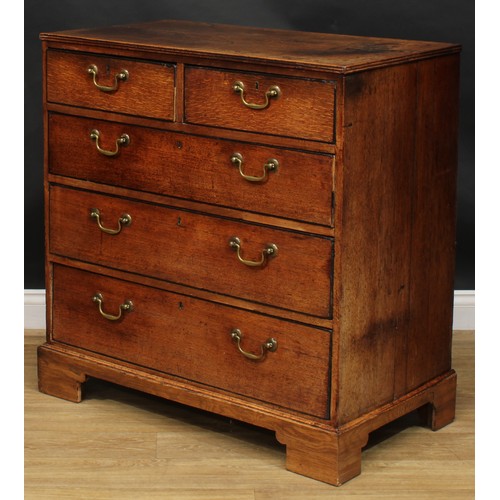 1942 - A George III oak chest, rectangular top with reeded edge above two short and three long graduated dr... 